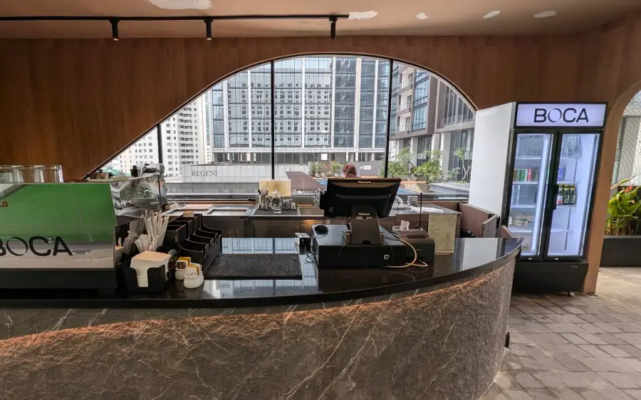 Bar counter with a curved timber arch and city view