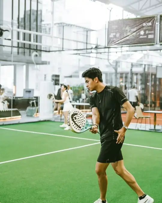Player walking across the green court