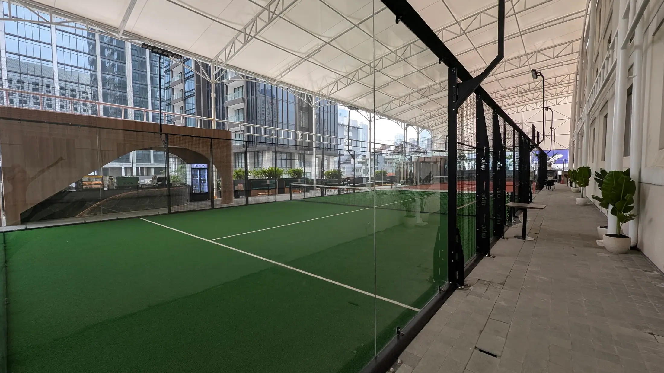 Court beside the glass with the city skyline beyond